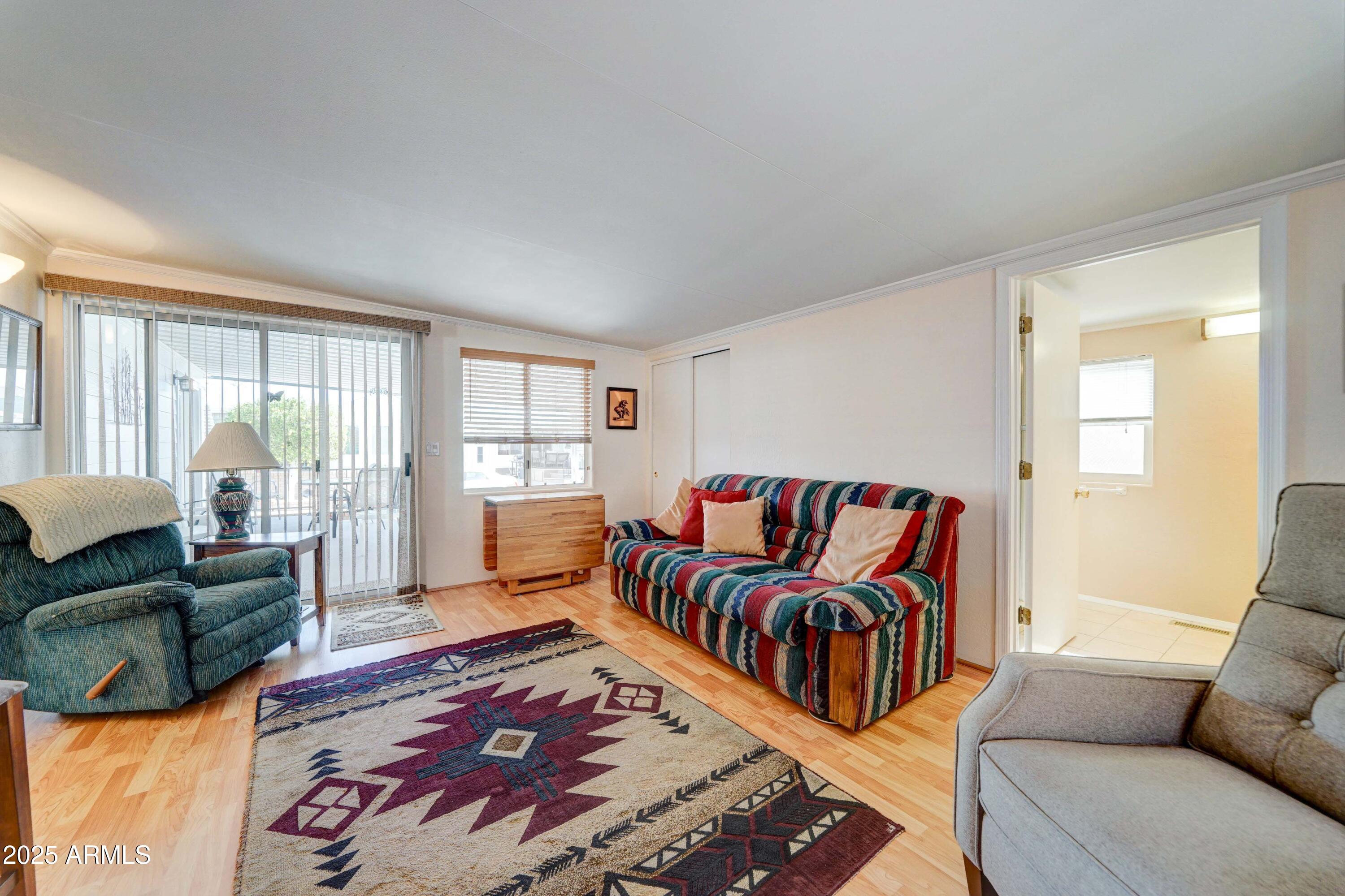 111 South Greenfield Road, Unit 440 Mesa, AZ 85206 - Photo 20 of 31 a living room with furniture and a large window