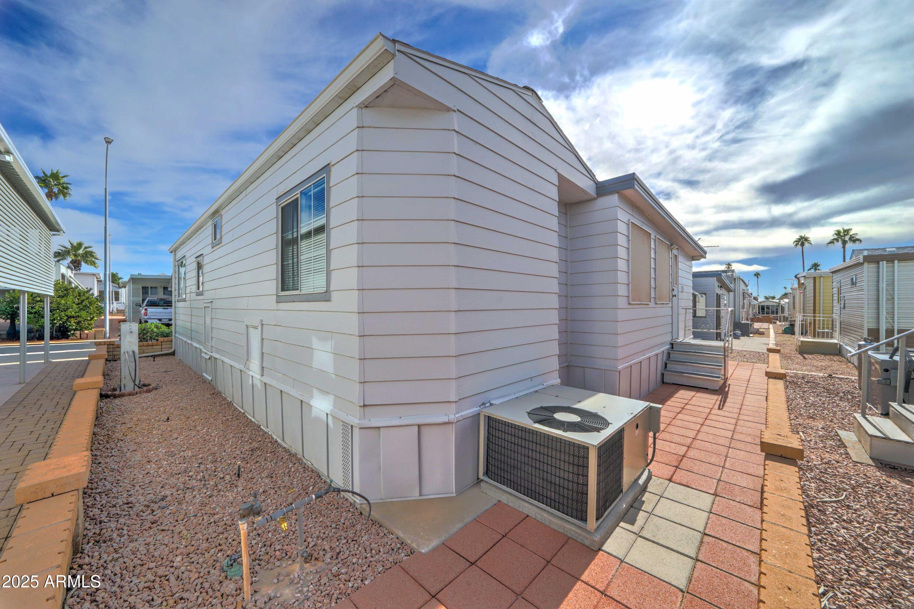 111 South Greenfield Road, Unit 440 Mesa, AZ 85206 - Photo 24 of 31 a front view of a house with parking space
