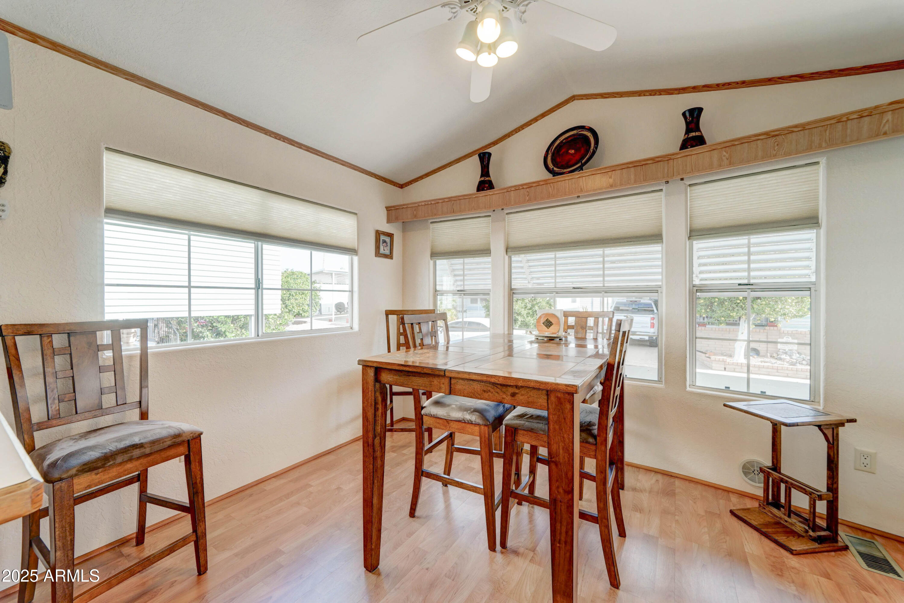111 South Greenfield Road, Unit 440 Mesa, AZ 85206 - Photo 6 of 31 a view of a dining room with furniture window and wooden floor