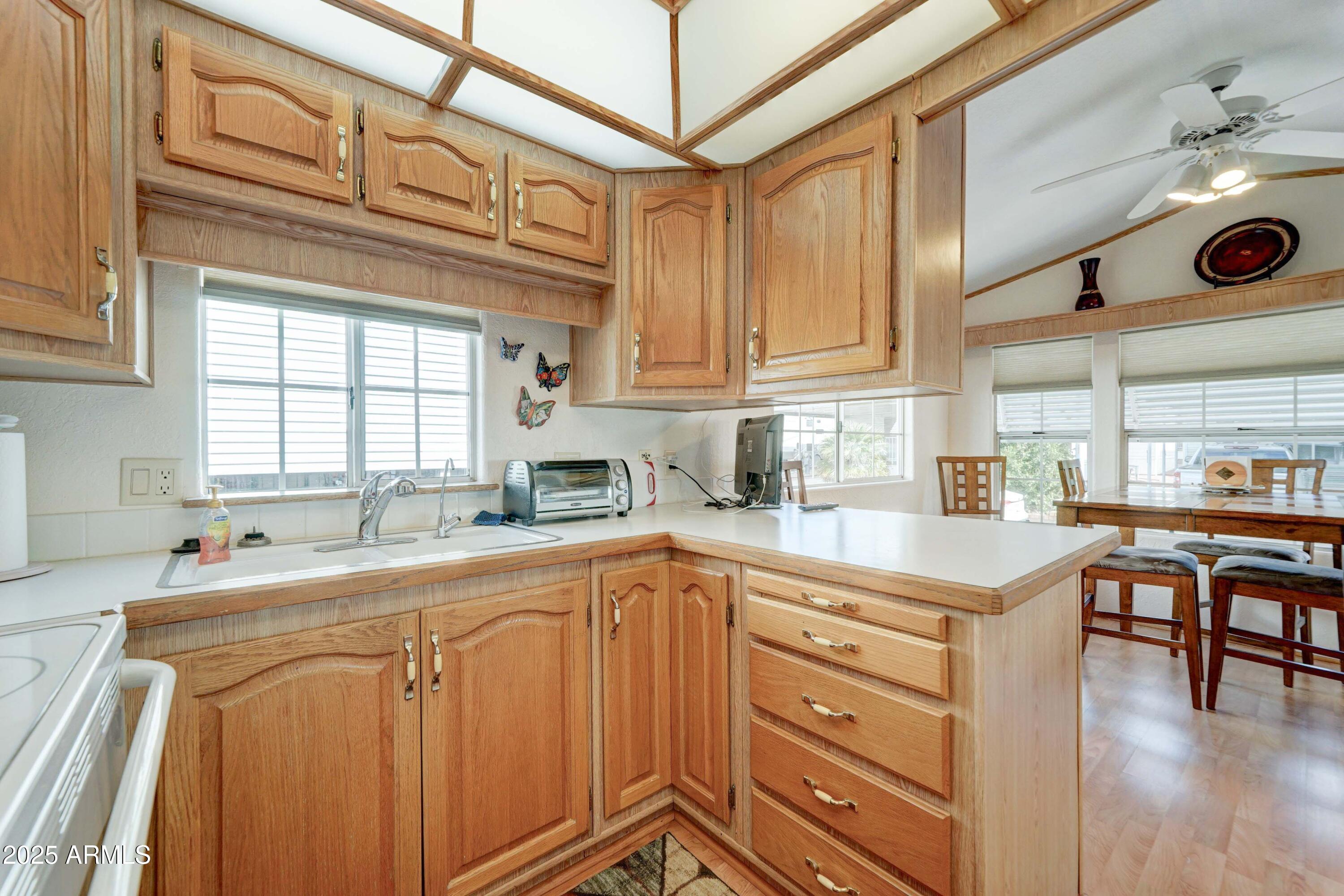 111 South Greenfield Road, Unit 440 Mesa, AZ 85206 - Photo 8 of 31 a kitchen with stainless steel appliances granite countertop a sink and cabinets