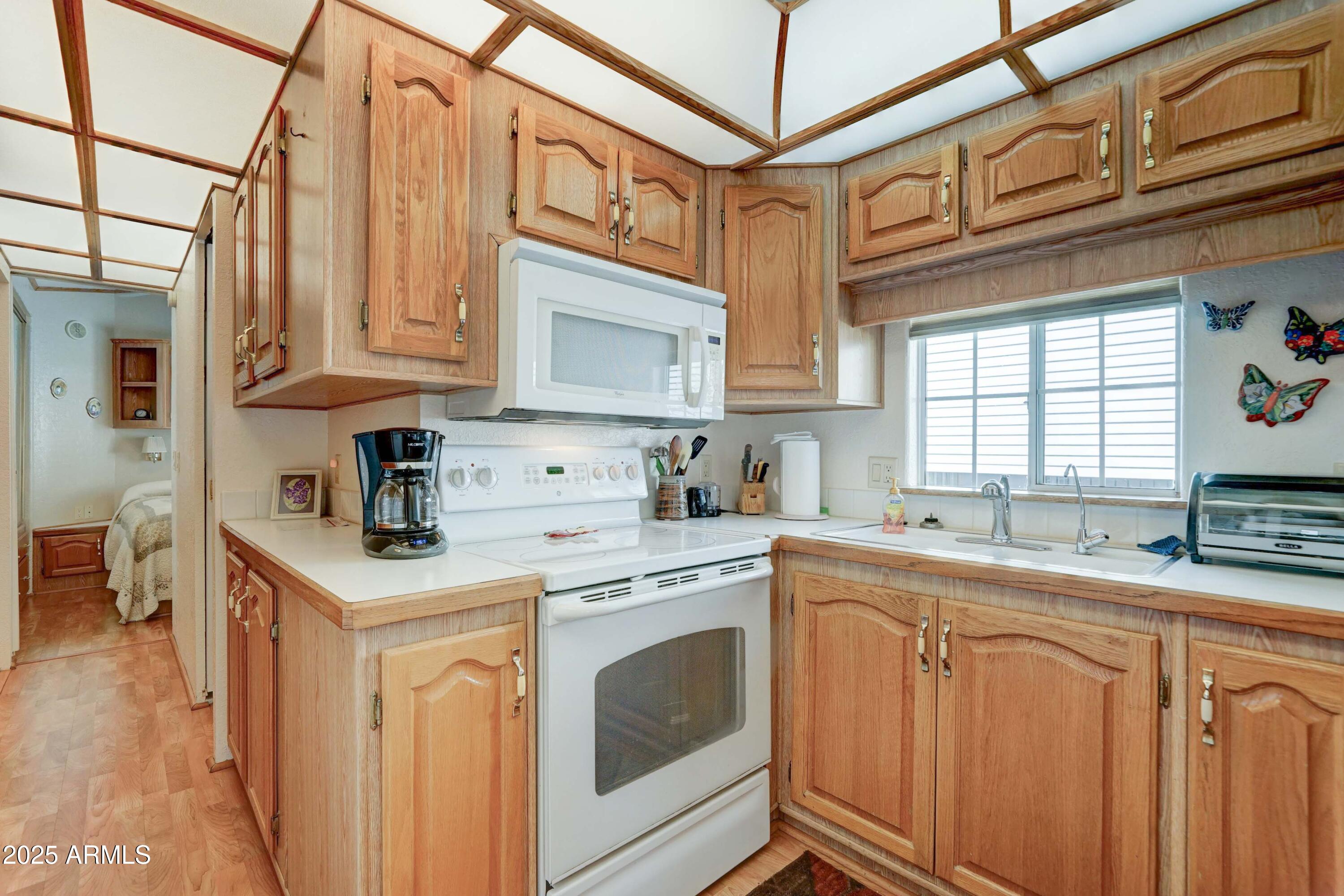111 South Greenfield Road, Unit 440 Mesa, AZ 85206 - Photo 9 of 31 a kitchen with stainless steel appliances granite countertop a sink a stove and cabinets