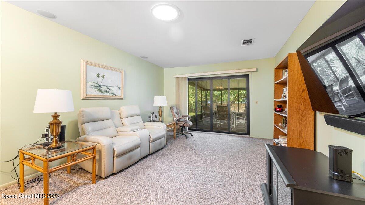 1683 Avery Road Northeast Palm Bay, FL 32905 - Photo 3 of 18 a living room with furniture and a flat screen tv
