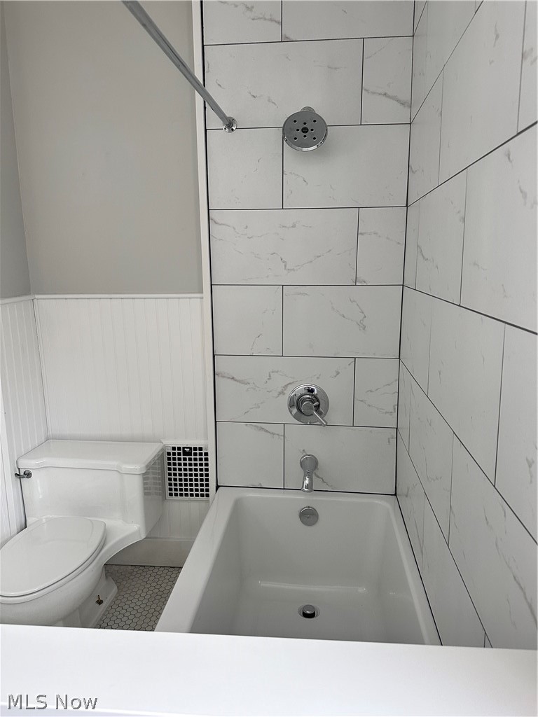 910 Cambridge Road Coshocton, OH 43812 - Photo 18 of 30 Upstairs bathroom with tiled shower / bath, tile floors, and toilet
