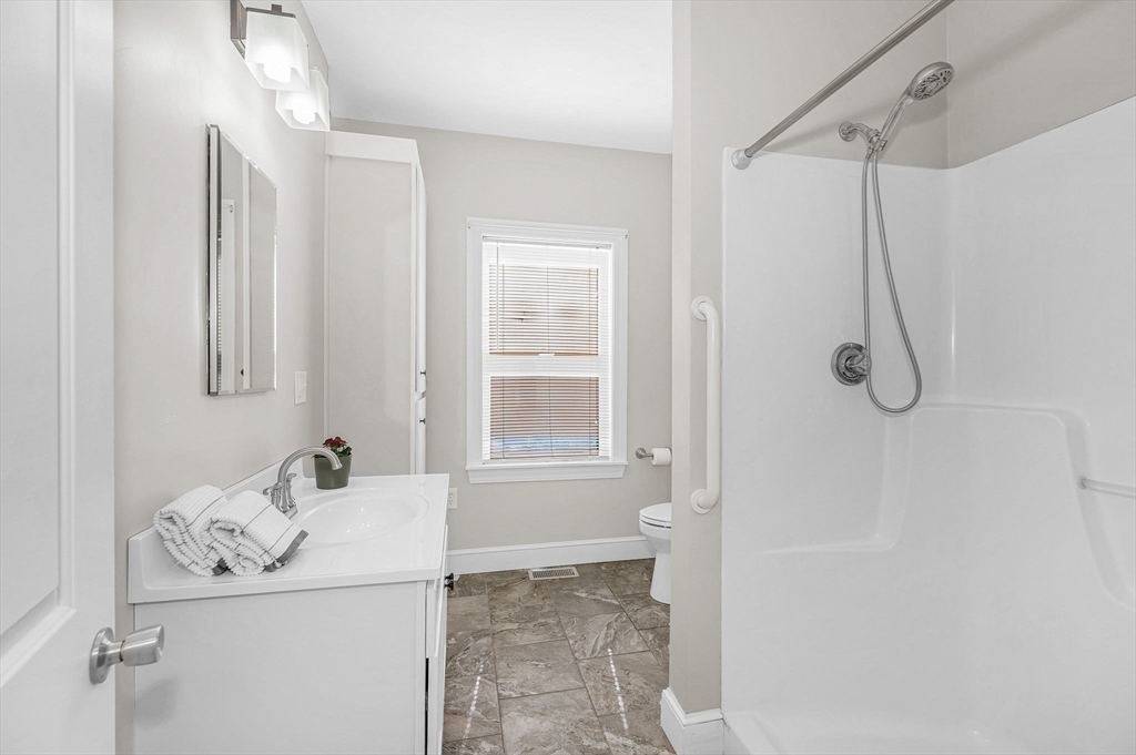 69 Ash Street Reading, MA 01867 - Photo 15 of 29 a bathroom with a sink and shower