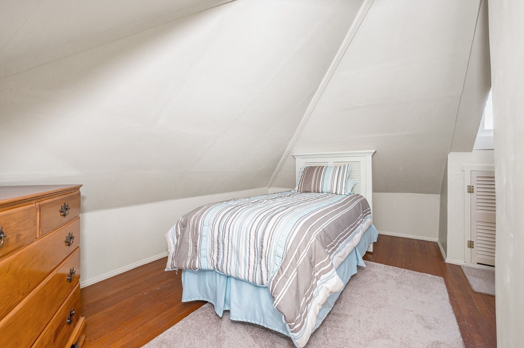 69 Ash Street Reading, MA 01867 - Photo 20 of 29 a bedroom with a bed and a window