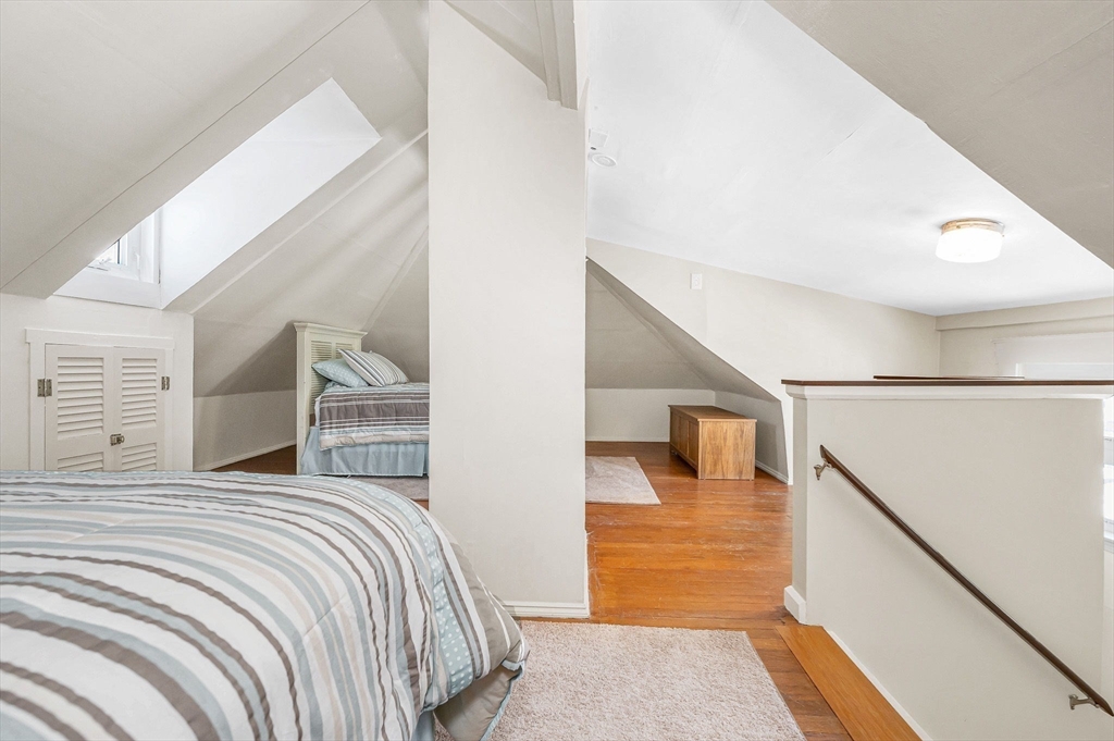 69 Ash Street Reading, MA 01867 - Photo 21 of 29 a bedroom with a bed and walk in closet