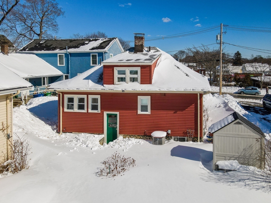 69 Ash Street Reading, MA 01867 - Photo 27 of 29 a front view of a house with a yard