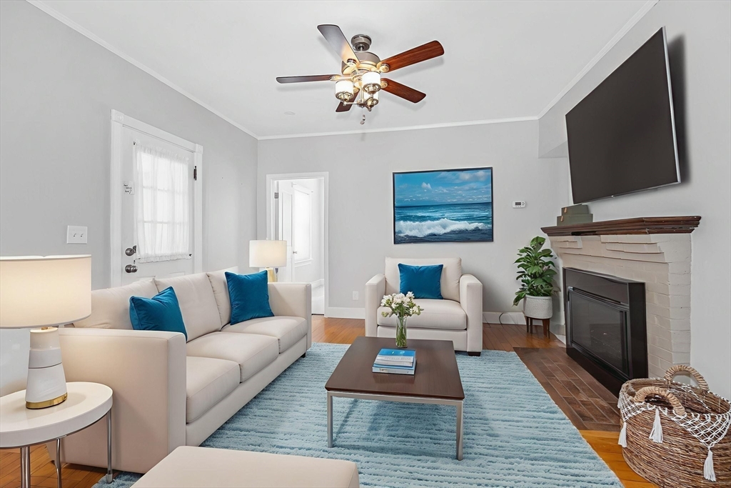 69 Ash Street Reading, MA 01867 - Photo 4 of 29 a living room with furniture fireplace and a flat screen tv