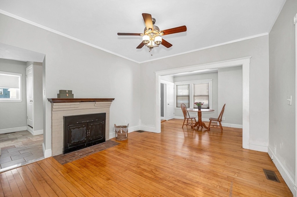 69 Ash Street Reading, MA 01867 - Photo 5 of 29 a view of livingroom with furniture fireplace and wooden floor