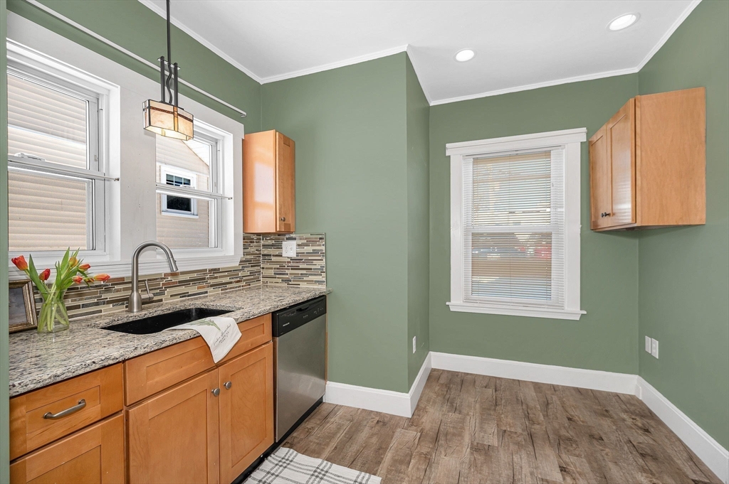 69 Ash Street Reading, MA 01867 - Photo 7 of 29 a bathroom with a granite countertop sink a mirror and a