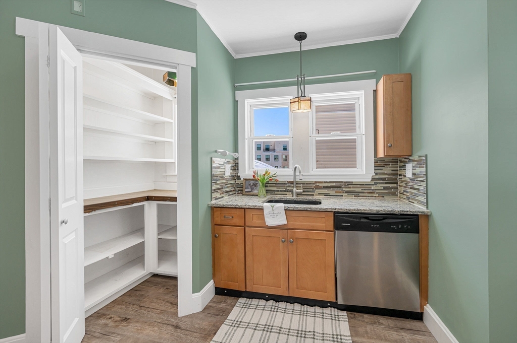 69 Ash Street Reading, MA 01867 - Photo 9 of 29 a kitchen with a sink stove and cabinets