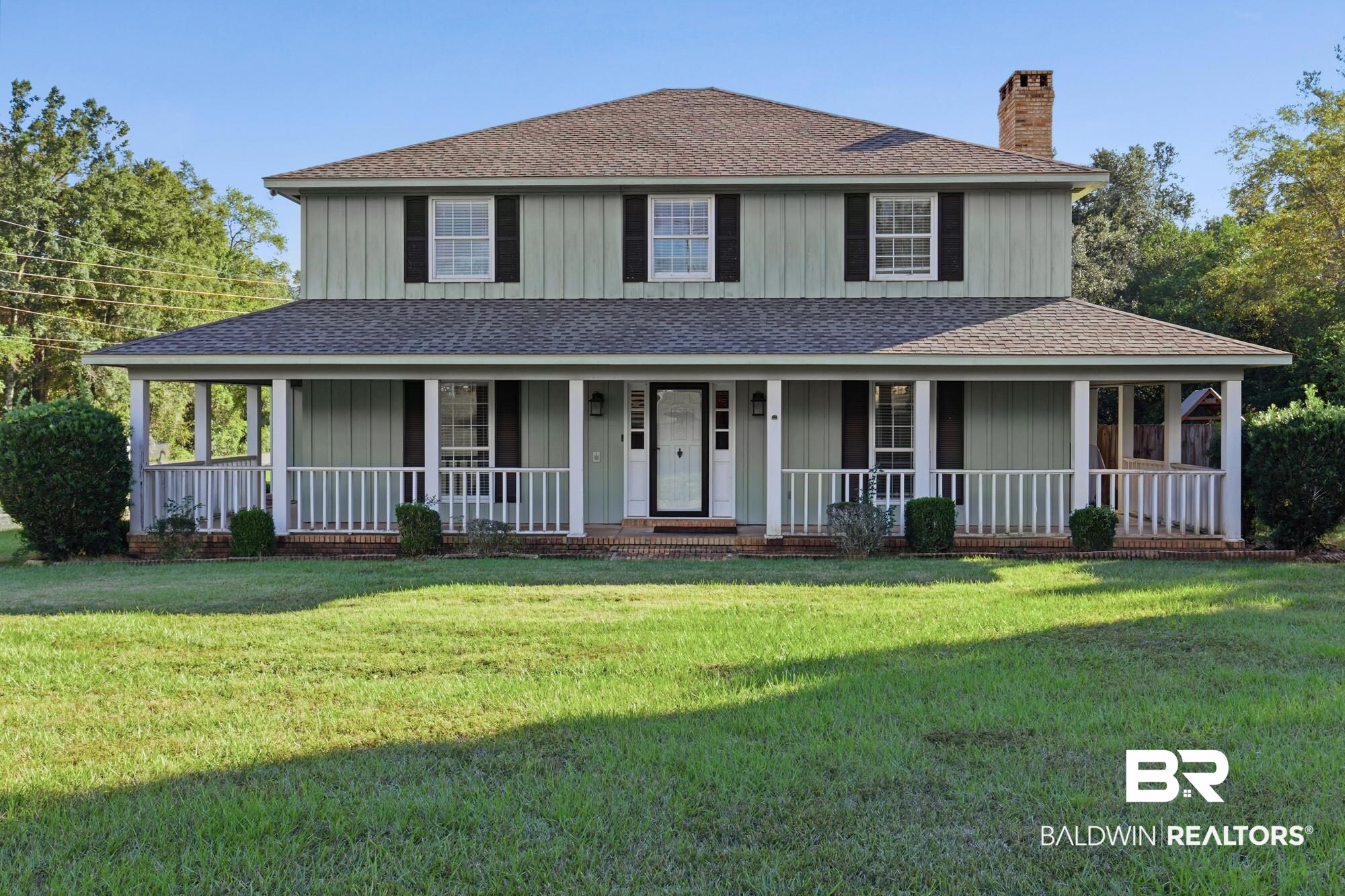 9215 Shiloh Drive Mobile, AL 36695 - Photo 1 of 32 View of front of property with roof with shingles, a porch, a chimney, a front yard, and board and batten siding