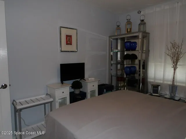 a bedroom with a bed and a lamp