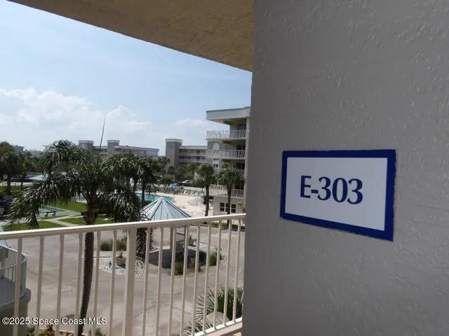 a living room with furniture and a painting on the wall