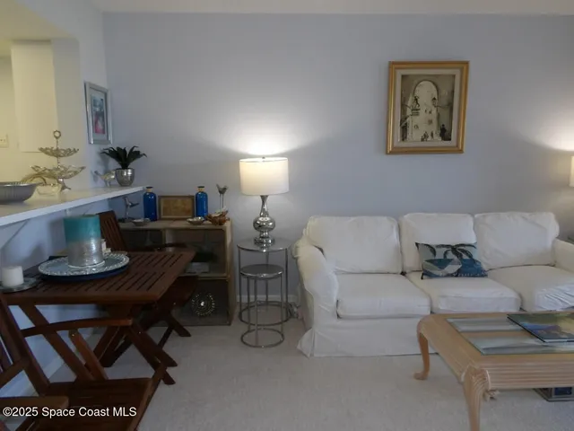 a living room with furniture a rug and a bathroom