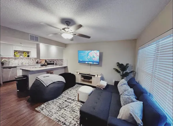 a living room with furniture and a chandelier