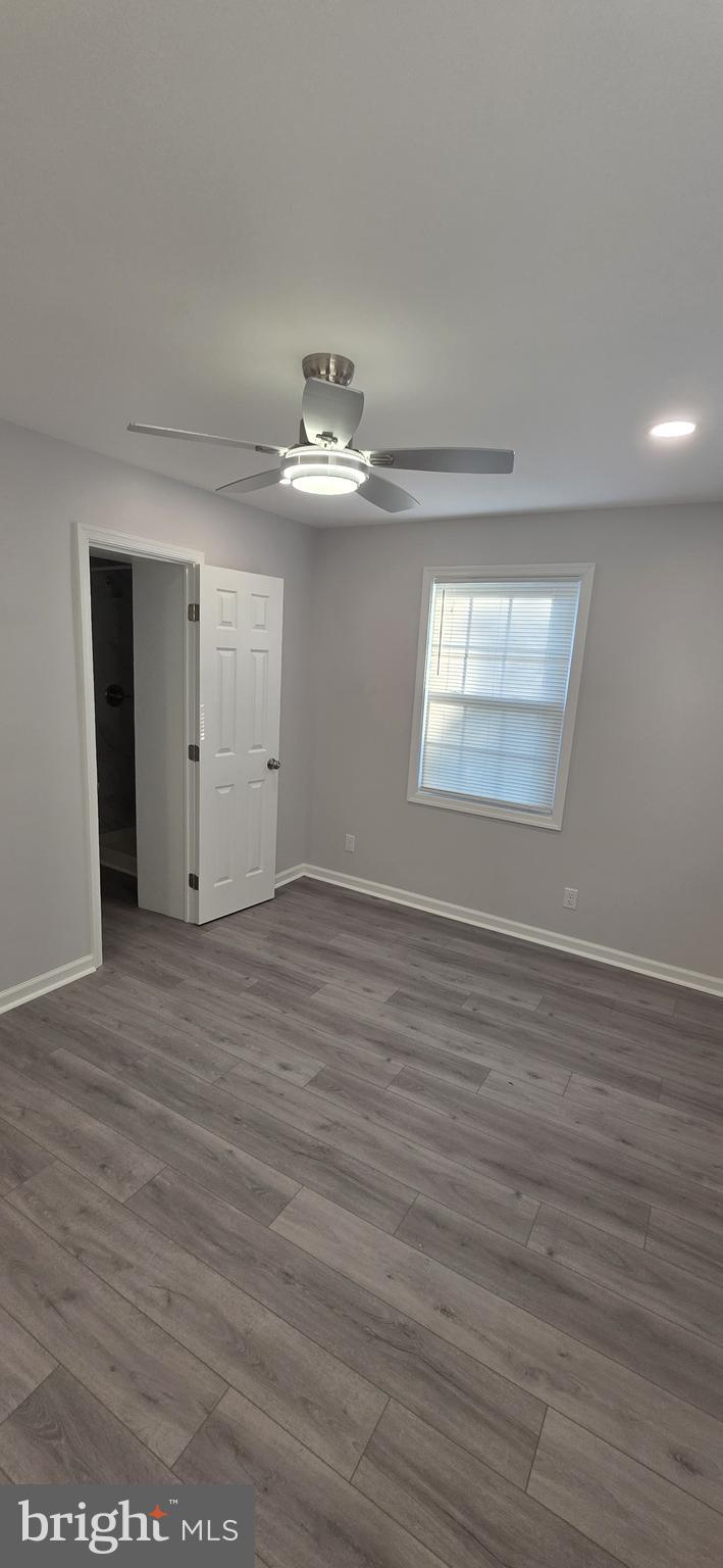 1400 Staples Street Northeast, Unit 1 Washington, DC 20002 - Photo 11 of 13 an empty room with wooden floor chandelier and windows