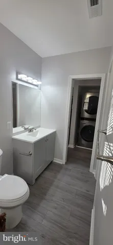 a bathroom with a sink a toilet and mirror