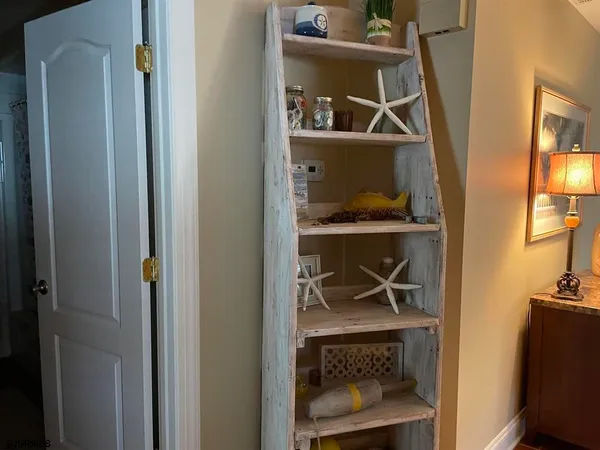 a living room with a fireplace and a mirror