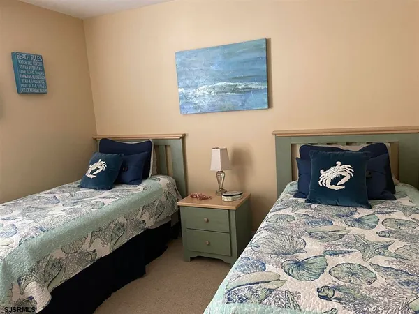 a bedroom with a bed and a wall painting