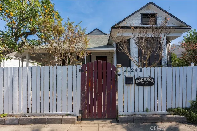 a front view of a house with outdoor seating and plants