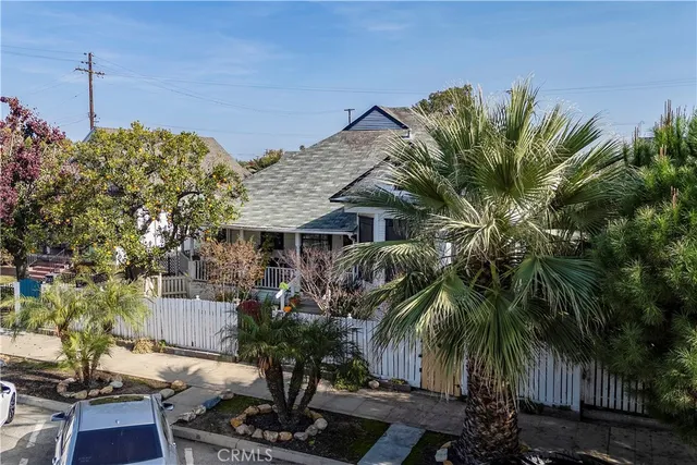 a front view of a house with wooden fence