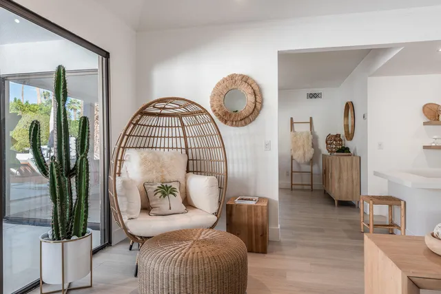 a dining room with furniture a chandelier and window