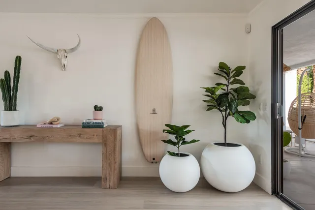 a bedroom with two beds and painting on the wall