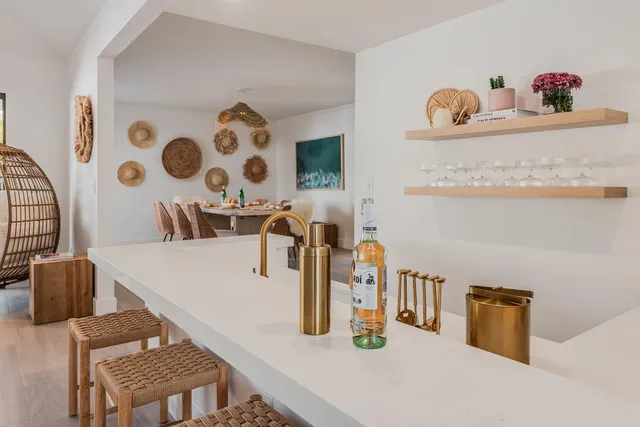 a spacious bedroom with a bed a table and a potted plant