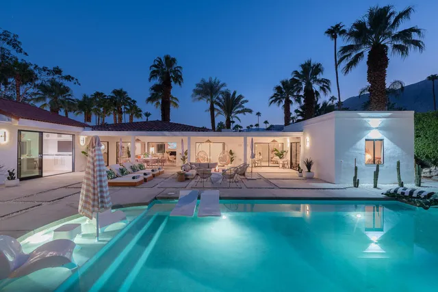 an outdoor sitting area with furniture and garden view