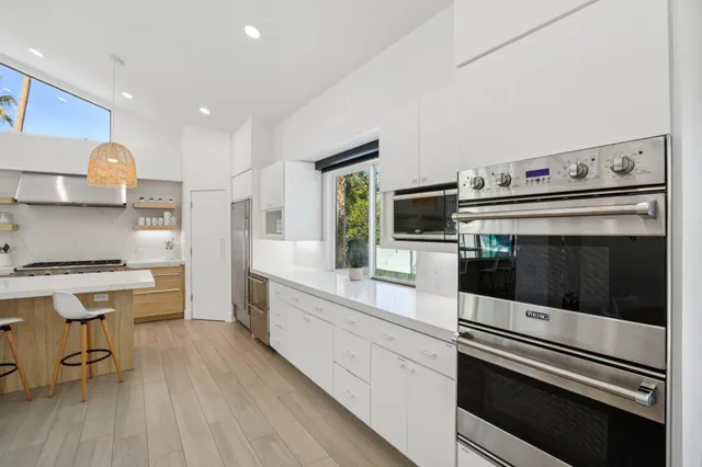 a view of living room filled with furniture and a potted plant
