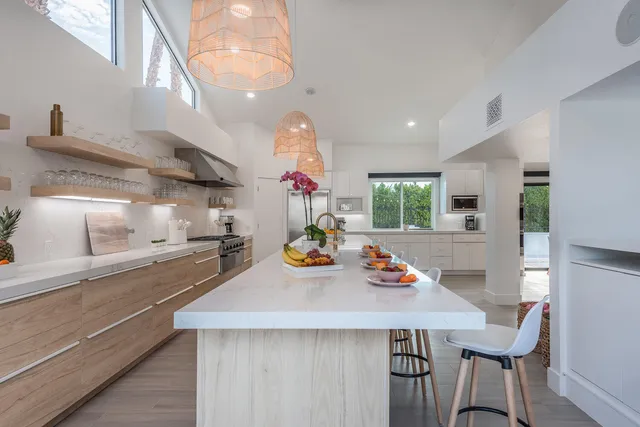 a view of a dining room with furniture large windows and wooden floor