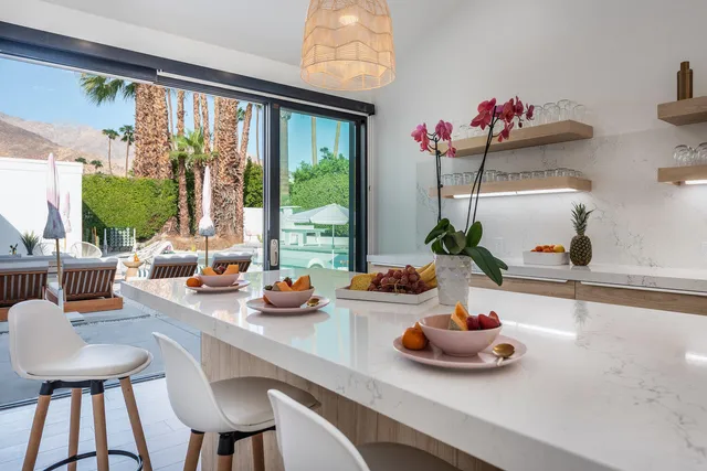 a view of a patio with table and chairs and potted plants