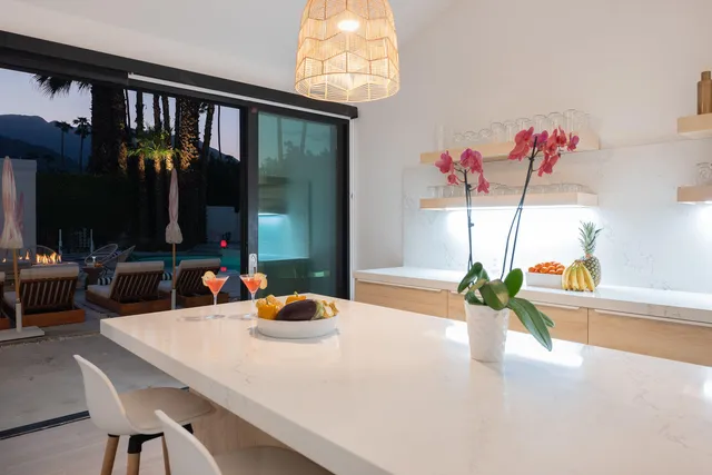 a view of a house with swimming pool and sitting area