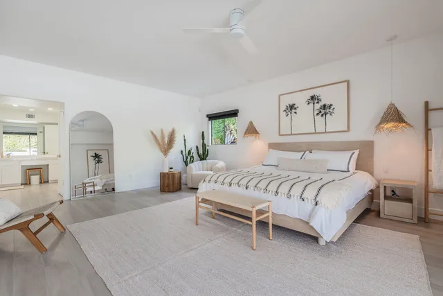 a front view of a house with garden and sitting area