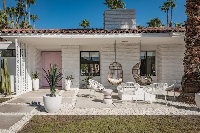a view of a dining room with furniture and a chandelier