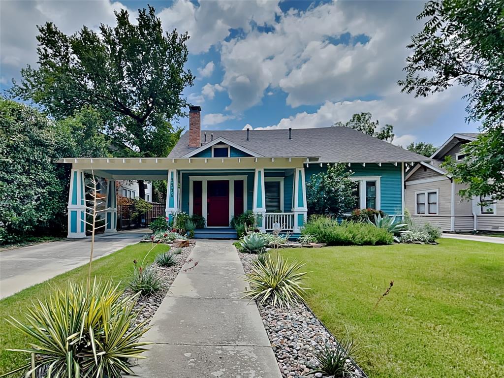 a front view of a house with a yard table and chairs