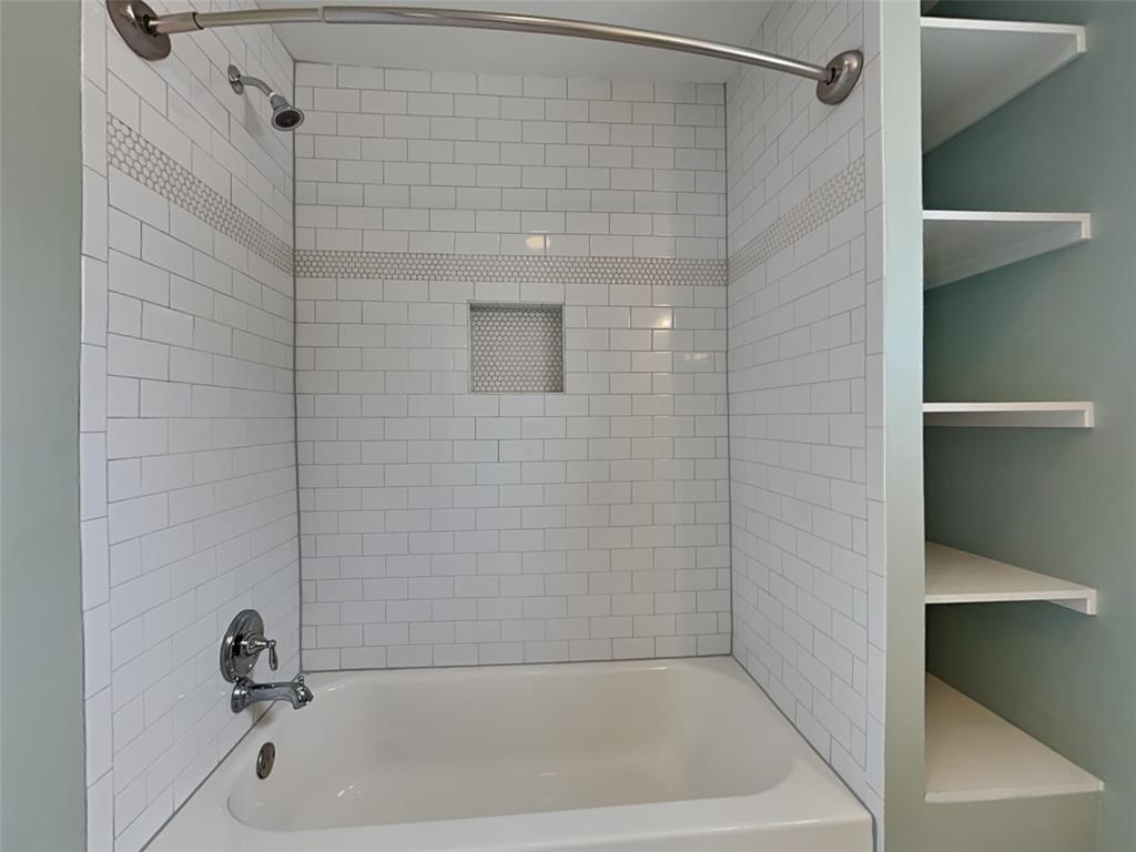 5536 Tremont Street Dallas, TX 75214 - Photo 14 of 21 a bathroom with a shower and a bathtub