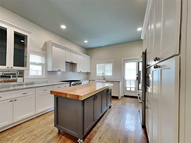 a kitchen with a stove a sink and a refrigerator