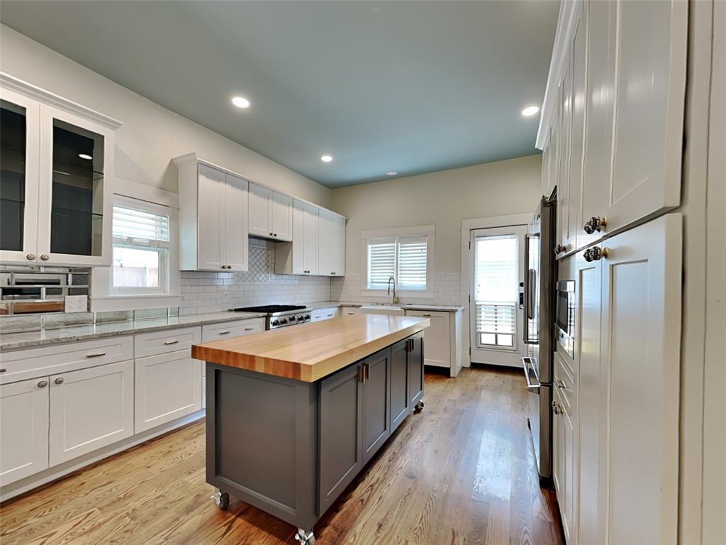 5536 Tremont Street Dallas, TX 75214 - Photo 5 of 21 a kitchen with a stove a sink and a refrigerator