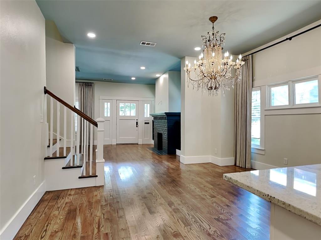 5536 Tremont Street Dallas, TX 75214 - Photo 6 of 21 a view of a hallway with wooden floor and staircase