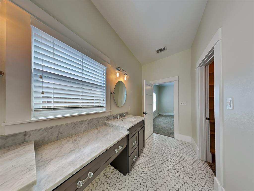 5536 Tremont Street Dallas, TX 75214 - Photo 9 of 21 a bathroom with a sink and a mirror