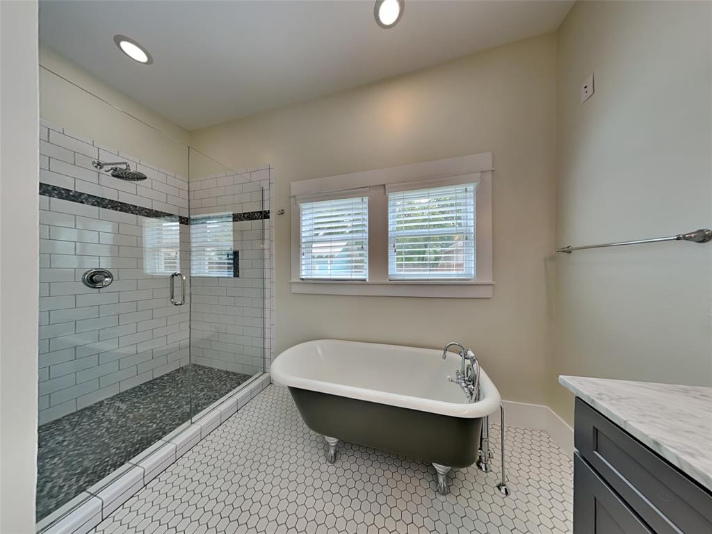 5536 Tremont Street Dallas, TX 75214 - Photo 10 of 21 a bathroom with a sink a toilet and shower