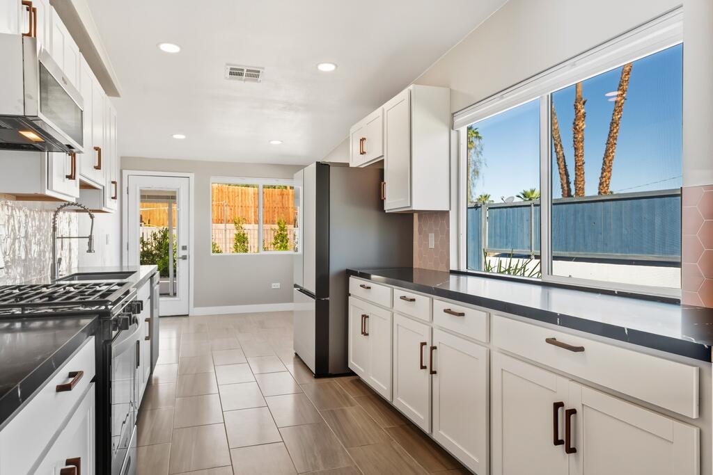 38855 Paradise Way Cathedral City, CA 92234 - Photo 13 of 67 a kitchen with granite countertop a stove a sink and a refrigerator