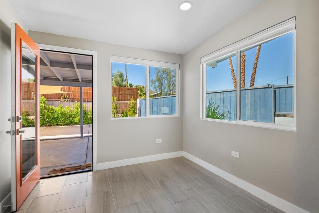 38855 Paradise Way Cathedral City, CA 92234 - Photo 17 of 67 a view of an empty room with wooden floor and a window