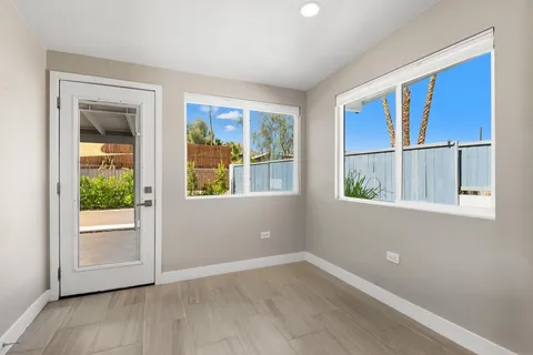 a bedroom with a bed and large window