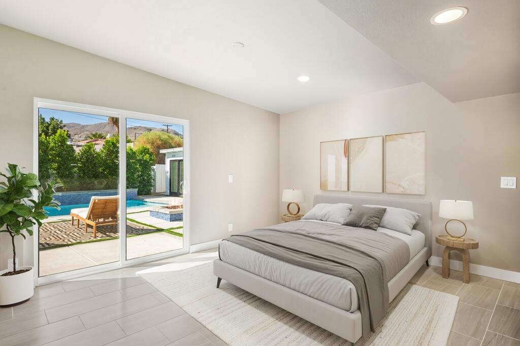 38855 Paradise Way Cathedral City, CA 92234 - Photo 19 of 67 a spacious bedroom with a bed and a couch