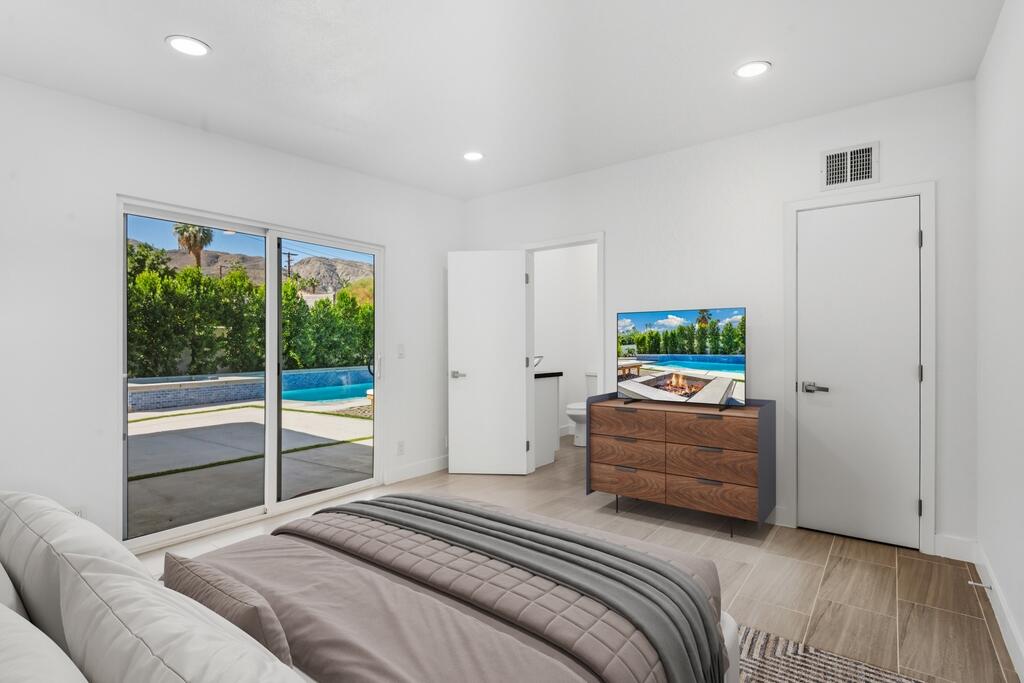 38855 Paradise Way Cathedral City, CA 92234 - Photo 24 of 67 a bedroom with a bed and large window