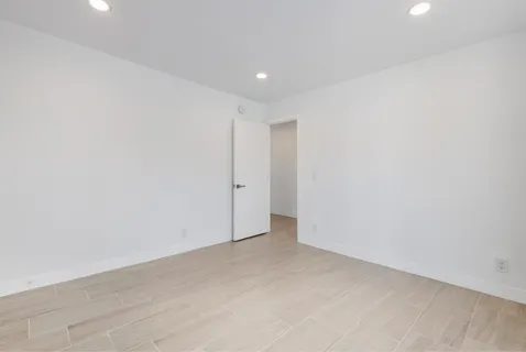 a view of an empty room with a window