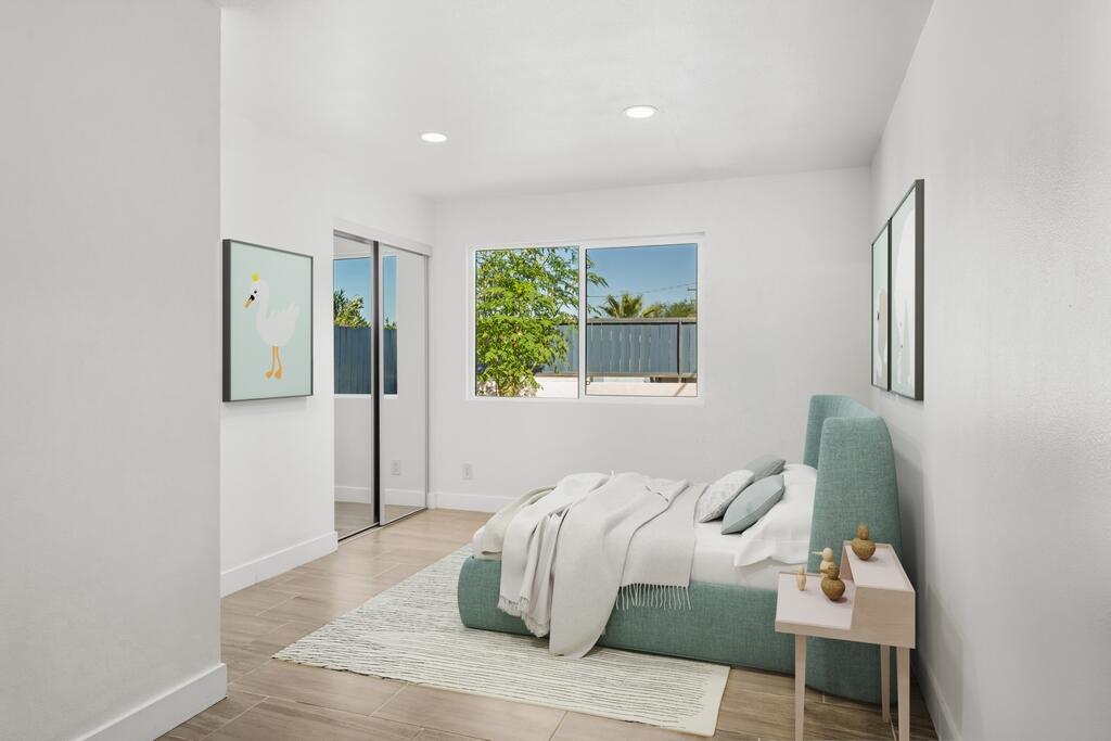 38855 Paradise Way Cathedral City, CA 92234 - Photo 30 of 67 a bedroom with a bed and wooden floor